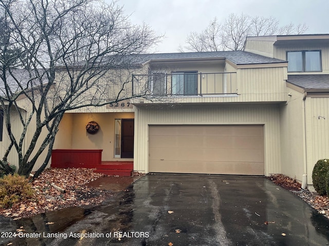 view of front of home featuring a garage and a balcony