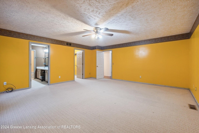 interior space with carpet flooring, a textured ceiling, and ceiling fan