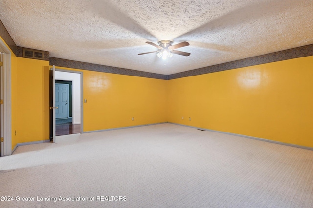 unfurnished room featuring carpet flooring, ceiling fan, and a textured ceiling