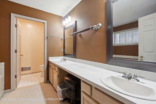 bathroom featuring tile patterned flooring, vanity, and toilet