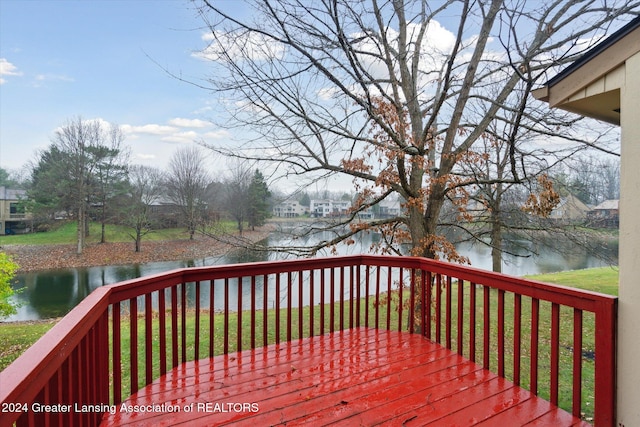 wooden terrace featuring a yard and a water view