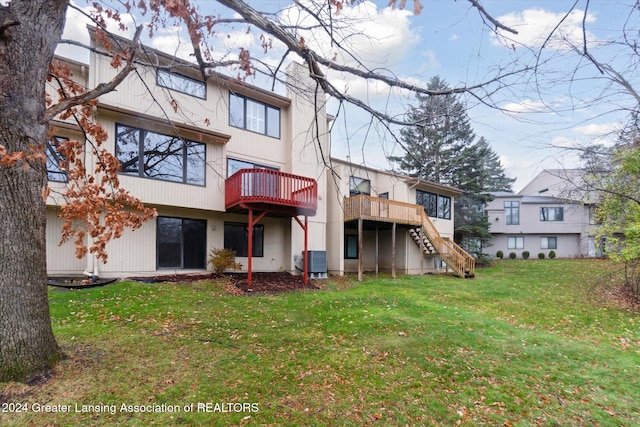 back of house with a yard, a deck, and central AC unit