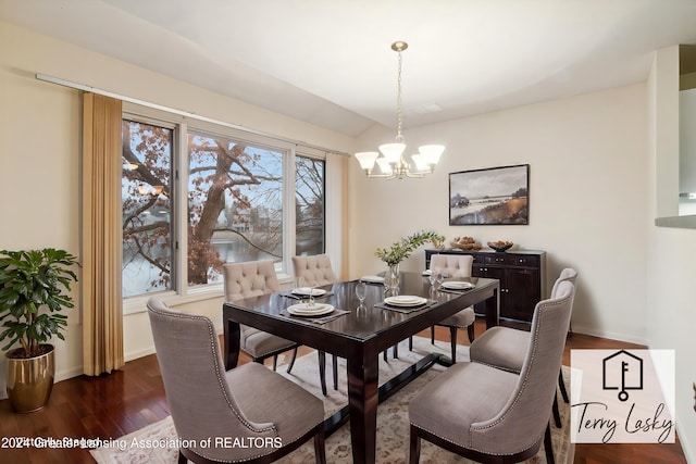 dining area featuring a notable chandelier and dark wood-type flooring