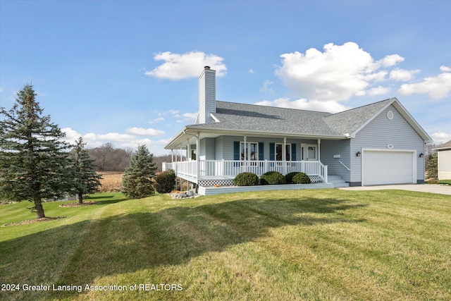 view of front of house featuring covered porch, a garage, and a front lawn