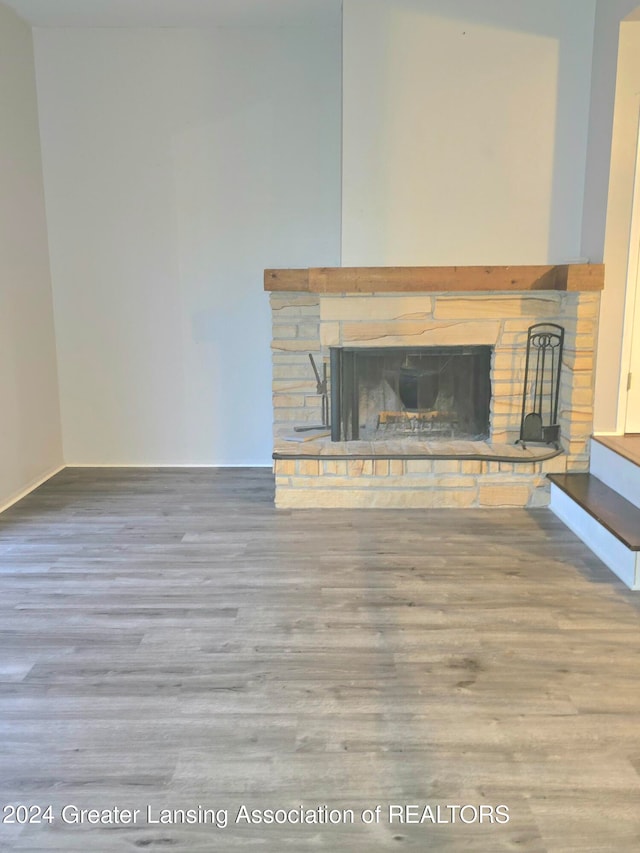 interior details with wood-type flooring and a fireplace