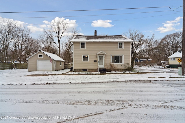 view of front property featuring a garage and an outbuilding