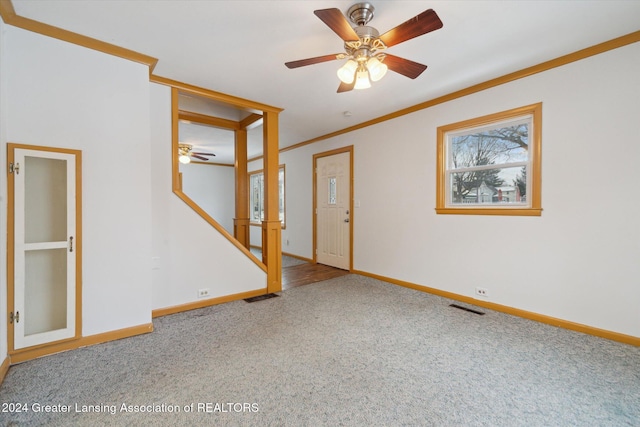 unfurnished room with carpet, ceiling fan, and ornamental molding