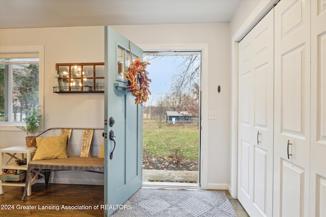 doorway to outside featuring light hardwood / wood-style floors and a chandelier