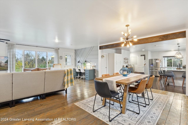 dining room with hardwood / wood-style flooring and a notable chandelier