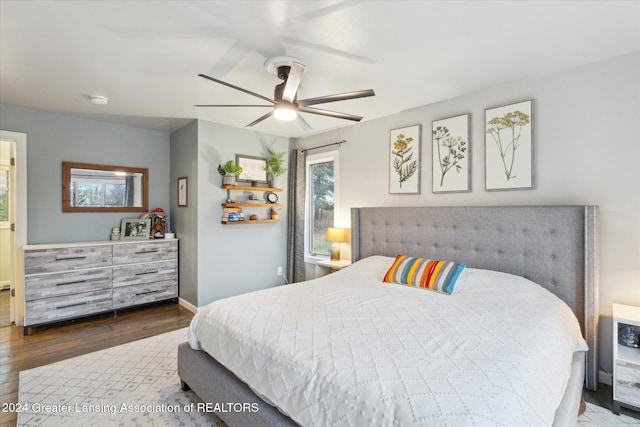 bedroom with ceiling fan and wood-type flooring