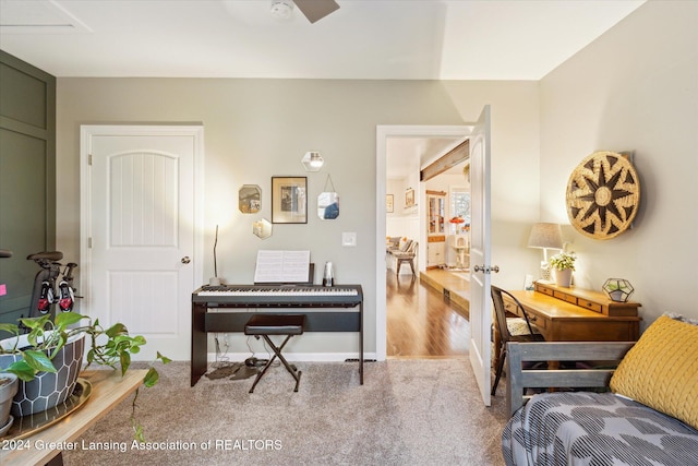 sitting room with wood-type flooring and ceiling fan