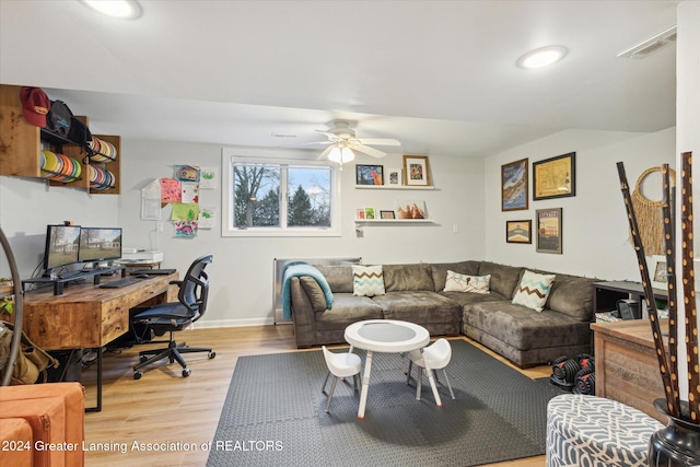 living room with ceiling fan and light wood-type flooring