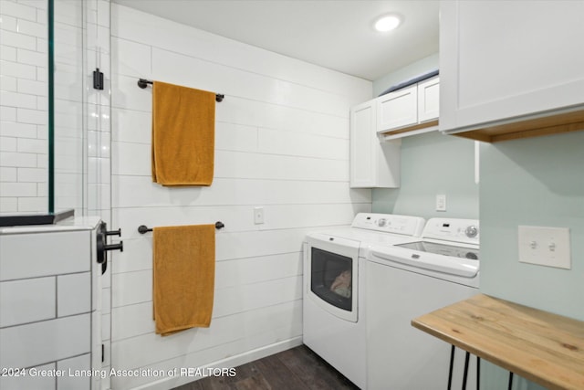 clothes washing area with dark hardwood / wood-style floors, cabinets, and washing machine and dryer