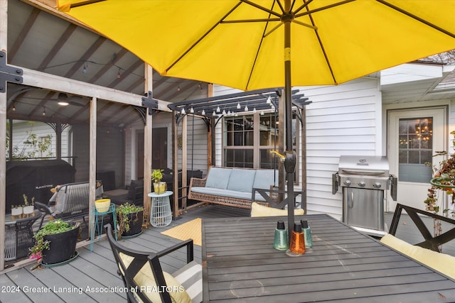 deck with a pergola, grilling area, and outdoor lounge area