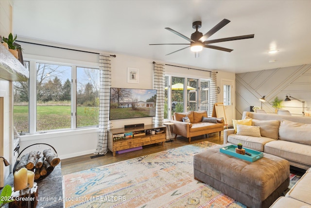 living room with ceiling fan, hardwood / wood-style floors, and a healthy amount of sunlight