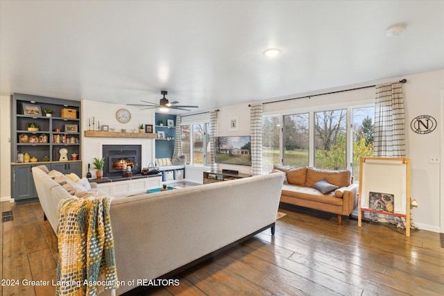 living room featuring dark hardwood / wood-style floors and ceiling fan