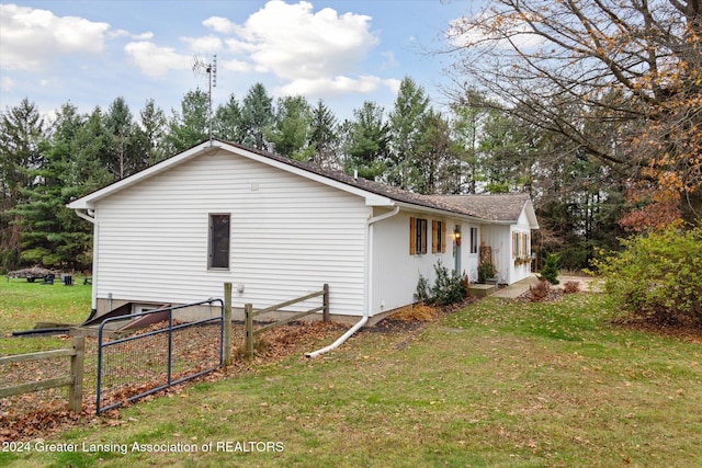 view of side of home with a lawn