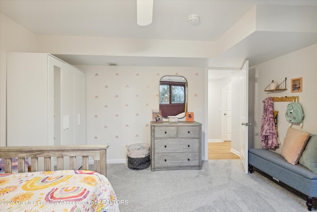 bedroom featuring light colored carpet and ceiling fan