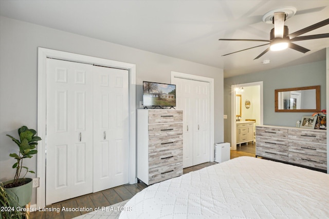 bedroom featuring connected bathroom, ceiling fan, and dark hardwood / wood-style flooring