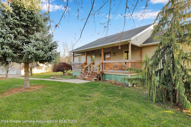 rear view of house with a lawn and covered porch