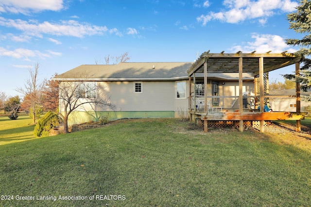 rear view of property with a lawn and a deck