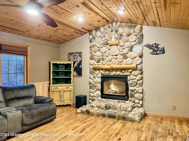 living room featuring a fireplace, light hardwood / wood-style floors, lofted ceiling, and wood ceiling