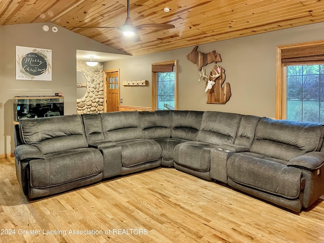 living room with light hardwood / wood-style flooring, a wealth of natural light, wooden ceiling, and ceiling fan