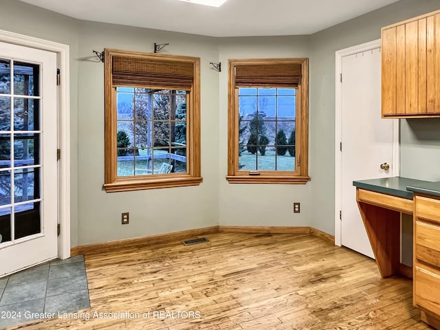 unfurnished dining area with a wealth of natural light and light hardwood / wood-style flooring