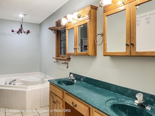 bathroom with vanity, tile patterned floors, and tiled tub