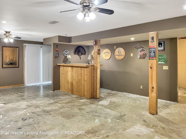 interior space featuring bar area and ceiling fan