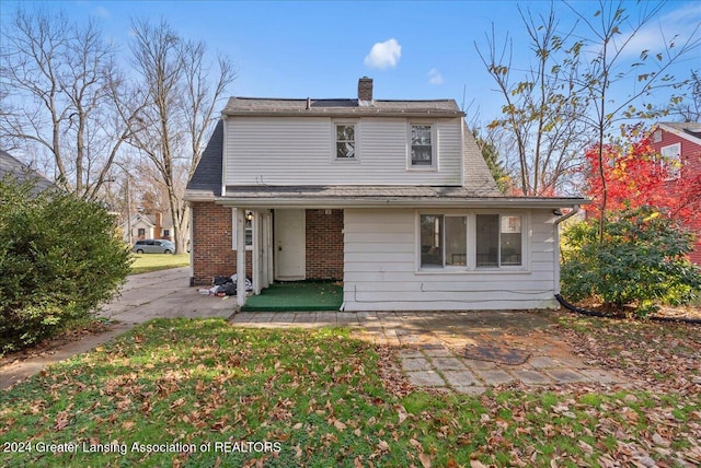 rear view of house with a yard