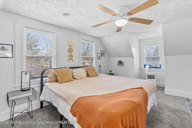 carpeted bedroom featuring a textured ceiling, vaulted ceiling, multiple windows, and ceiling fan