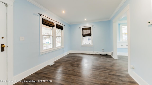 empty room featuring dark hardwood / wood-style floors and crown molding