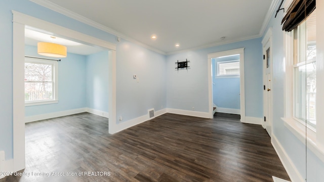 empty room with dark hardwood / wood-style floors and ornamental molding