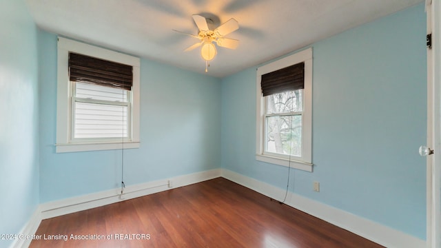 unfurnished room with ceiling fan and dark hardwood / wood-style flooring