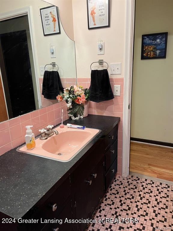 bathroom featuring vanity and tasteful backsplash