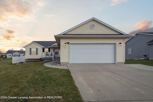 view of front facade featuring a yard and a garage