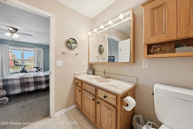 bathroom featuring tile patterned floors, ceiling fan, vanity, and toilet