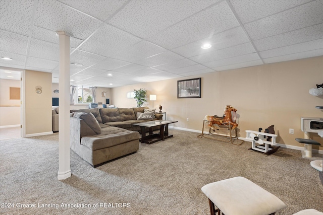 carpeted living room with a drop ceiling