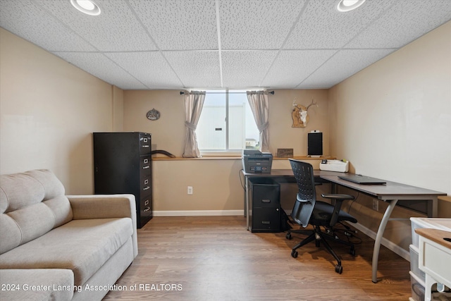 office featuring a paneled ceiling and wood-type flooring