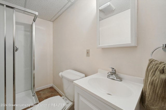 bathroom with vanity, toilet, and a shower with shower door