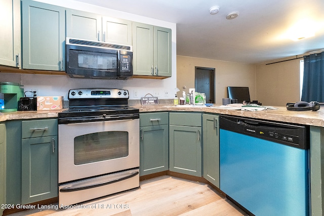 kitchen with green cabinetry, stainless steel dishwasher, light hardwood / wood-style floors, electric range oven, and kitchen peninsula