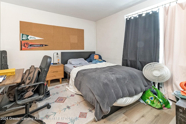 bedroom with wood-type flooring