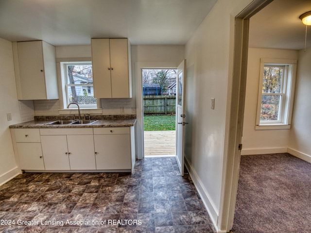 kitchen with a healthy amount of sunlight, white cabinetry, and sink