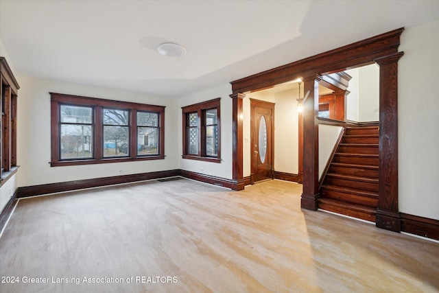 interior space with wood-type flooring, ornate columns, and plenty of natural light