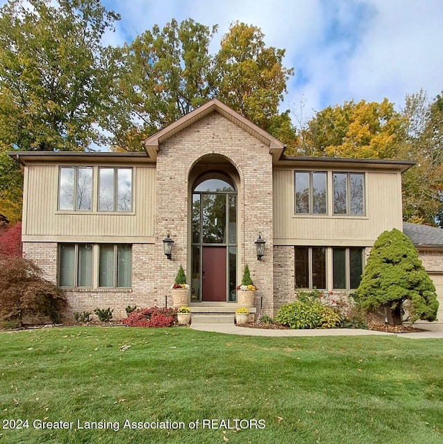 split foyer home with a front lawn