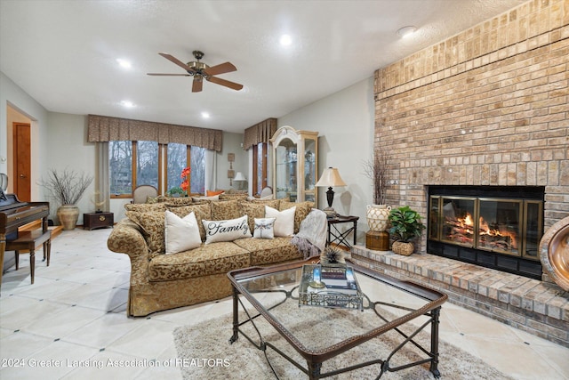 living room featuring a brick fireplace and ceiling fan