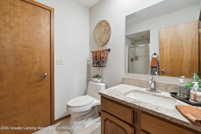 bathroom featuring vanity, an enclosed shower, and toilet