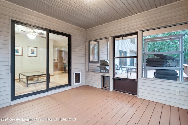 unfurnished sunroom featuring ceiling fan and wood ceiling