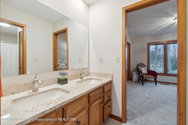 bathroom featuring a textured ceiling and vanity